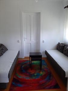 a living room with a couch and a table on a rug at Holiday Home Stella in Vrdnik