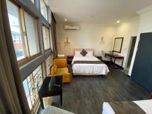 a hotel room with two beds and a window at Kenting Heng-Chung Art Hostel in Hengchun