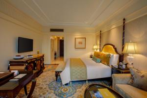 a hotel room with a bed and a desk at The Leela Palace New Delhi in New Delhi