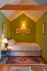 sypialnia z łóżkiem w zielonej ścianie w obiekcie The Lady Maxwell Room at Buittle Castle w mieście Dalbeattie