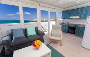 a living room with a couch and a table at Arinaga Colors, tu casa en la playa in Arinaga