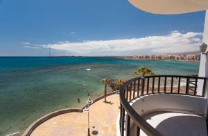 a view of the ocean from the balcony of a building at Arinaga Colors, tu casa en la playa in Arinaga