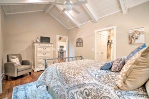 a bedroom with a bed and a chair at Hootenanny at Horton Creek Creekside Escape! in Helen