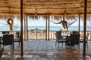 a dining room with a view of the ocean at Mirage Hotel in Shekhvetili