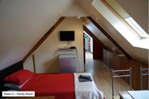 a bedroom with a bed and a tv in the attic at Pentre Riding Stables in Abercraf
