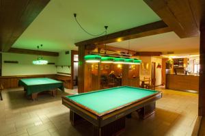 a pool table in a room with a ping pong ball at Albergo Antelao in San Vito di Cadore