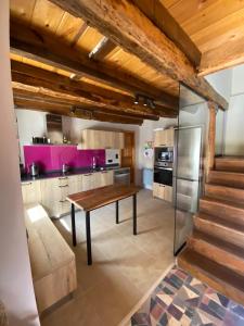 a kitchen with a wooden table in a room at La Casita de Verdiago in Verdiago