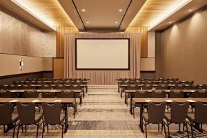 an empty lecture hall with tables and chairs at Live! by Loews - St. Louis in Saint Louis