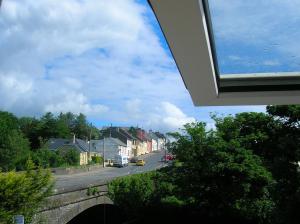 a view of a street with houses and a bridge at Riverbank Cottages in Scarriff