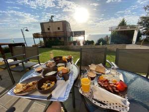 a table with a tray of breakfast food on it at Hemingway rooms in Happy Beach in Varna City
