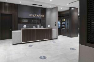 a lobby with a reception desk in a building at Holiday Inn Express - Boston Logan Airport - Revere, an IHG Hotel in Revere