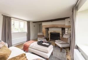 a living room with a couch and a fireplace at Manor Farmhouse in Dorchester