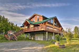 a large wooden house with a wrap around porch at Legacy Mountain Lodge on 40-Acre Ranch with Views! in Palmer