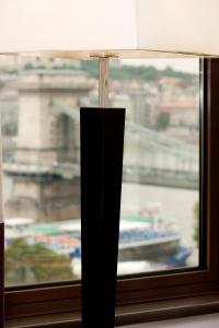 a lamp sitting next to a window with a view at Sofitel Budapest Chain Bridge in Budapest