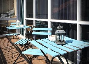 a blue picnic table and two chairs on a porch at Quartier Bilbao Hostel Casco Viejo in Bilbao