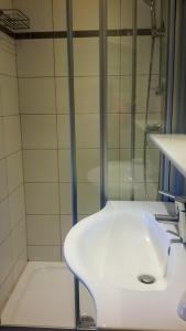 a bathroom with a white sink and a shower at Superior Apartment Recktenwald in Bad Gastein