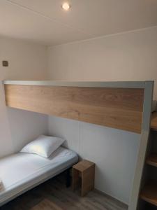 a small room with a bunk bed and a shelf at Cap Océan in Seignosse