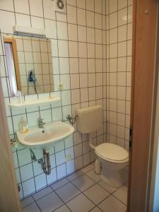 a bathroom with a toilet and a sink at Messe Motel Laatzen in Hannover