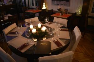 a table with wine glasses and candles on it in a restaurant at Hotel Restaurant Meints4you im Bürgerhof in Recklinghausen