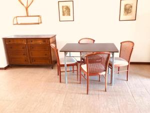 une table à manger avec des chaises et une commode en bois dans l'établissement Hola Vulcano, à Vulcano