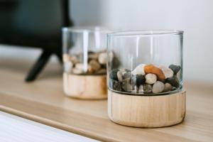 two glass containers filled with rocks on a table at Casa Com Piscina no Coração do Douro - Domaine Casa Valença, in Valença do Douro