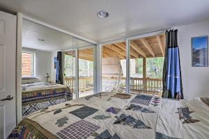 a bedroom with two beds and a balcony at Bright Fairplay Cabin with Deck and All-Seasons Fun! in Fairplay