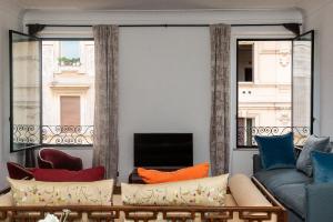 a living room with a couch and a large window at Amazing New Penthouse with terrace Jewish Ghetto in Rome