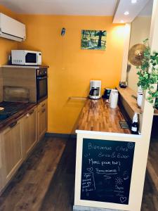 a kitchen with a counter with a chalkboard in it at House with nice garden, downtown by walk in Vaison-la-Romaine