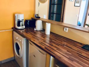 a kitchen counter with a coffee maker and a microwave at House with nice garden, downtown by walk in Vaison-la-Romaine +10 photos