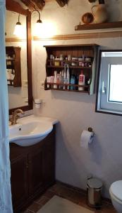 a bathroom with a sink and a toilet and a window at Casa Cuculo - Rustico mit traumhaftem Meerblick in Scansano +20 photos