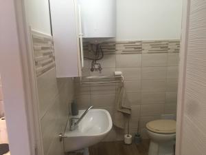 a small bathroom with a sink and a toilet at Kiss Apartman Uppony in Uppony +34 photos