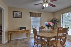 a dining room with a table and a ceiling fan at Updated Gulf Coast Home with Yard Near the Beach! in Dauphin Island