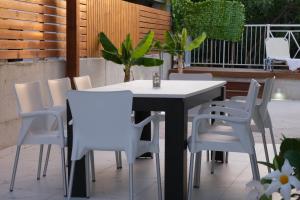 a white table and chairs on a patio at Luxury Fani House Next to Harbor area with Jacuzzi in Paphos