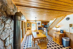 a dining room with a table and a stone wall at Lake Eden Escape in Eden