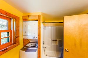 a small kitchen with a refrigerator and a window at Lake Eden Escape in Eden +41 photos