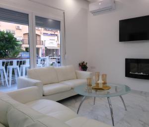 a living room with a white couch and a table at Luxury Fani House Next to Harbor area with Jacuzzi in Paphos