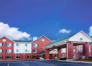a large red brick building with a parking lot at Holiday Inn Express Chicago Northwest-Vernon Hills, an IHG Hotel in Vernon Hills
