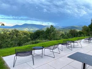 a group of chairs and tables on a patio at Hôtel 48°Nord & Restaurant, The Originals Relais in Breitenbach