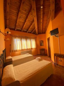 a bedroom with two beds and a flat screen tv at Hotel Hostería de Monzón in Monzón de Campos +19 photos