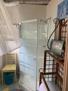 a glass shower in a room with a table at The Purple Martin Lakeside Inn Bird Sanctuary on Lake Huron in Rogers City