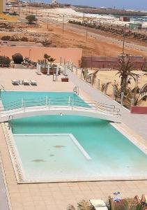 a large swimming pool next to a beach at Residence Por Do Sol, Praia Cabral, Boa Vista, Cape Verde, FREE WI-FI in Sal Rei