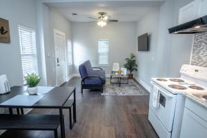 a kitchen and living room with a table and a stove at Remodeled Historic 1BR 1BA House Near Downtown in San Antonio