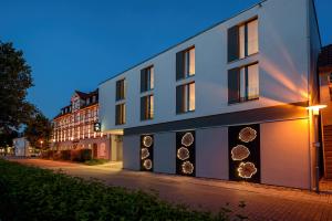 a building with spheres on the side of it at AKZENT Hotel Laupheimer Hof in Laupheim