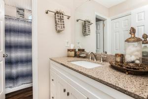 a bathroom with a sink and a mirror at The BoatHouse in Marco Island