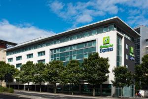 an office building with a sign on the side of it at Holiday Inn Express Newcastle City Centre, an IHG Hotel in Newcastle upon Tyne