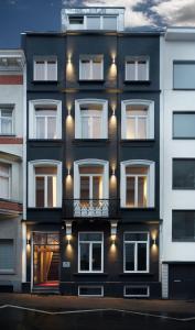 a black and white building with a balcony at Hotel The Neufchatel in Brussels