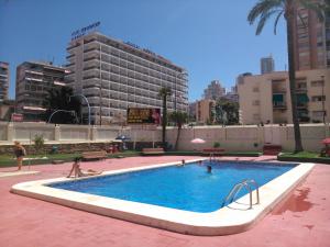 a swimming pool in a city with people in it at Blue Sky apartment in Benidorm