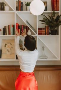 a woman is reaching into a book shelf at The Masons Arms Hotel in Louth