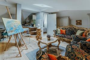 a living room with a painting on a easel at Baltic Sea Dunes Apartments in Jūrmala