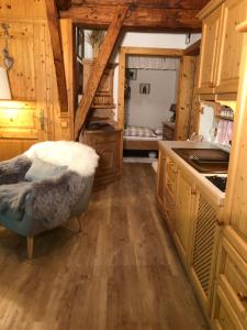 a kitchen with a couch in the middle of a room at Alte Mühle Appartements in Seefeld in Tirol